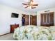 Spacious bedroom boasts a tropical themed bed, closet, and wall-mounted TV at 33620 Picciola Dr, Fruitland Park, FL 34731