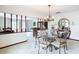 Elegant dining room featuring a glass table, chandelier, and nautical-themed decor and views to the living room at 33620 Picciola Dr, Fruitland Park, FL 34731