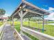 Covered boat dock over a tranquil lake provides shelter and a lift, enhancing waterfront living with direct water access at 33620 Picciola Dr, Fruitland Park, FL 34731