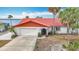Charming single-story home with red tile roof, attached garage, and landscaping at 33620 Picciola Dr, Fruitland Park, FL 34731