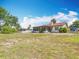 Charming home with a red tile roof, screened in porch, and large yard perfect for outdoor activities at 33620 Picciola Dr, Fruitland Park, FL 34731