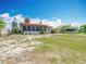Lovely single-story home featuring a red tile roof, expansive yard, and a screened in back porch at 33620 Picciola Dr, Fruitland Park, FL 34731