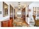 Long hallway featuring closet doors, wood flooring, and accent lighting at 33620 Picciola Dr, Fruitland Park, FL 34731