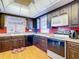 Well-lit kitchen featuring dark wood cabinets, red tile backsplash, and modern appliances at 33620 Picciola Dr, Fruitland Park, FL 34731