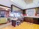 Open-concept kitchen featuring wood cabinetry, and breakfast bar leading to the living room with a fireplace at 33620 Picciola Dr, Fruitland Park, FL 34731