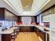 Traditional kitchen featuring wood cabinetry, a coffered ceiling, and breakfast nook with window views at 33620 Picciola Dr, Fruitland Park, FL 34731