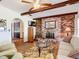 Comfortable living room featuring a brick fireplace, wood floors, and archway access at 33620 Picciola Dr, Fruitland Park, FL 34731