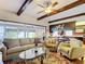 Spacious living room with wood floors leading to the adjacent kitchen and sunroom at 33620 Picciola Dr, Fruitland Park, FL 34731