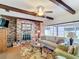 Cozy living room featuring a brick fireplace, wood beams, and sliding glass doors to the porch at 33620 Picciola Dr, Fruitland Park, FL 34731