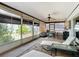 Relax in sunroom with waterfront view, lounge chairs, dining table, perfect for year round enjoyment at 33620 Picciola Dr, Fruitland Park, FL 34731