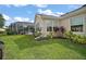 Lush backyard with vibrant landscaping and screened-in pool, perfect for outdoor living at 342 Mccormick Ln, The Villages, FL 32162