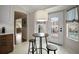Kitchen breakfast nook with counter seating, white door to patio, and view of pool at 342 Mccormick Ln, The Villages, FL 32162