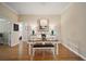 Formal dining room with wood floors, dining table with bench seating, and buffet with lamps at 342 Mccormick Ln, The Villages, FL 32162