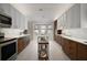 Bright kitchen with white and wood cabinetry, stainless appliances, island, and breakfast nook with pool views at 342 Mccormick Ln, The Villages, FL 32162