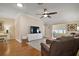 Comfortable living room area showcasing hardwood floors, a ceiling fan, and modern recessed lighting at 342 Mccormick Ln, The Villages, FL 32162