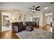 Cozy living room with wood floors, recessed lighting, and an open floor plan leading to the kitchen at 342 Mccormick Ln, The Villages, FL 32162