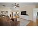 Spacious living room featuring hardwood floors, ceiling fan, and an open layout perfect for entertaining at 342 Mccormick Ln, The Villages, FL 32162