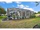 Backyard features a screened-in pool, lounge area, and lush green grass at 342 Mccormick Ln, The Villages, FL 32162