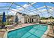 Relaxing pool area with a screened enclosure, brick patio, and plenty of space for outdoor lounging at 342 Mccormick Ln, The Villages, FL 32162
