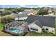 Home with screen-enclosed pool and well-manicured lawn and landscaping at 342 Mccormick Ln, The Villages, FL 32162