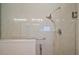 Walk in shower with safety bars, adjustable shower head, and smooth tile walls at 342 Mccormick Ln, The Villages, FL 32162