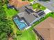 Aerial view of house featuring a screened-in pool and solar panels on the roof at 3534 Auburndale Ave, The Villages, FL 32162