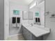 Bathroom featuring gray cabinets, a large mirror, neutral walls, and modern fixtures at 3534 Auburndale Ave, The Villages, FL 32162