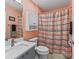 Bathroom featuring blue gray cabinets, a mirror, and a shower with a striped curtain at 3534 Auburndale Ave, The Villages, FL 32162