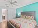 A well-lit bedroom featuring hardwood flooring and an ensuite bathroom at 3534 Auburndale Ave, The Villages, FL 32162