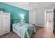 Bright bedroom featuring a decorative bed, a closet, light walls and wood floor at 3534 Auburndale Ave, The Villages, FL 32162