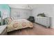 A well-lit bedroom featuring hardwood flooring, ceiling fan, and a recliner at 3534 Auburndale Ave, The Villages, FL 32162