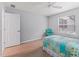 Bedroom with a decorative bed, light walls, wood floors, and closet at 3534 Auburndale Ave, The Villages, FL 32162