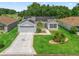 Charming home with well-manicured lawn, a two car garage, solar panels and inviting curb appeal at 3534 Auburndale Ave, The Villages, FL 32162