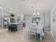 Modern kitchen and dining area with stainless steel appliances, a large island, and plenty of natural light at 3534 Auburndale Ave, The Villages, FL 32162