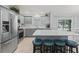 Stylish kitchen featuring stainless steel appliances, gray cabinets, and a spacious island with barstool seating at 3534 Auburndale Ave, The Villages, FL 32162