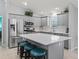 Modern kitchen with stainless steel appliances, gray cabinets, and a large island with seating at 3534 Auburndale Ave, The Villages, FL 32162