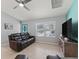 Inviting living room with tile floors, a large window, comfortable seating, and a teal accent wall at 3534 Auburndale Ave, The Villages, FL 32162