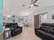 Open-concept living space with views of the kitchen, dining area, and sliding barn door at 3534 Auburndale Ave, The Villages, FL 32162