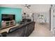 Open concept living room flows into the kitchen and dining area with tile floors and plenty of natural light at 3534 Auburndale Ave, The Villages, FL 32162