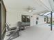 Covered patio offering a fan, string lights, plenty of space, and access to the screened-in pool at 3534 Auburndale Ave, The Villages, FL 32162