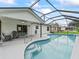 Stunning screened-in pool with ladder and patio chairs, perfect for outdoor enjoyment at 3534 Auburndale Ave, The Villages, FL 32162