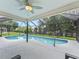 Refreshing screened-in pool area perfect for leisure, featuring a spacious patio and backyard views at 3534 Auburndale Ave, The Villages, FL 32162