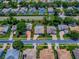 An aerial view shows the home nestled amongst other residences in a mature planned community at 3775 Brantley Place Cir, Apopka, FL 32703