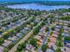 An aerial view shows the home in a well-established neighborhood with a lake nearby at 3775 Brantley Place Cir, Apopka, FL 32703