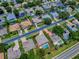 A home features a backyard pool and mature landscaping in this aerial community view at 3775 Brantley Place Cir, Apopka, FL 32703