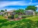 Lush backyard with well-manicured lawn, mature landscaping, and a screened-in pool at 3775 Brantley Place Cir, Apopka, FL 32703