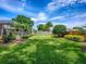 Spacious backyard featuring manicured lawn, garden beds, and perimeter landscaping at 3775 Brantley Place Cir, Apopka, FL 32703