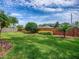 Green backyard with lawn and planting beds and a privacy fence at 3775 Brantley Place Cir, Apopka, FL 32703