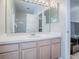 Spacious bathroom featuring a wide vanity with mirror and ample storage, with a partial view of a shower at 3775 Brantley Place Cir, Apopka, FL 32703