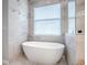 Bathroom with soaking tub, attractive tile work, and modern fixtures at 3775 Brantley Place Cir, Apopka, FL 32703